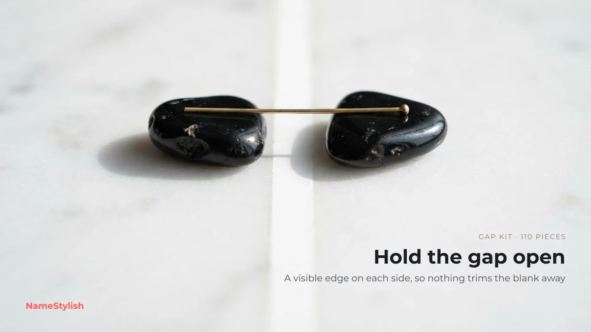 Invisible name gap kit — visible edges that hold a blank gap open Two black stones held apart by a brass pin on white marble, illustrating a gap held open by visible edges